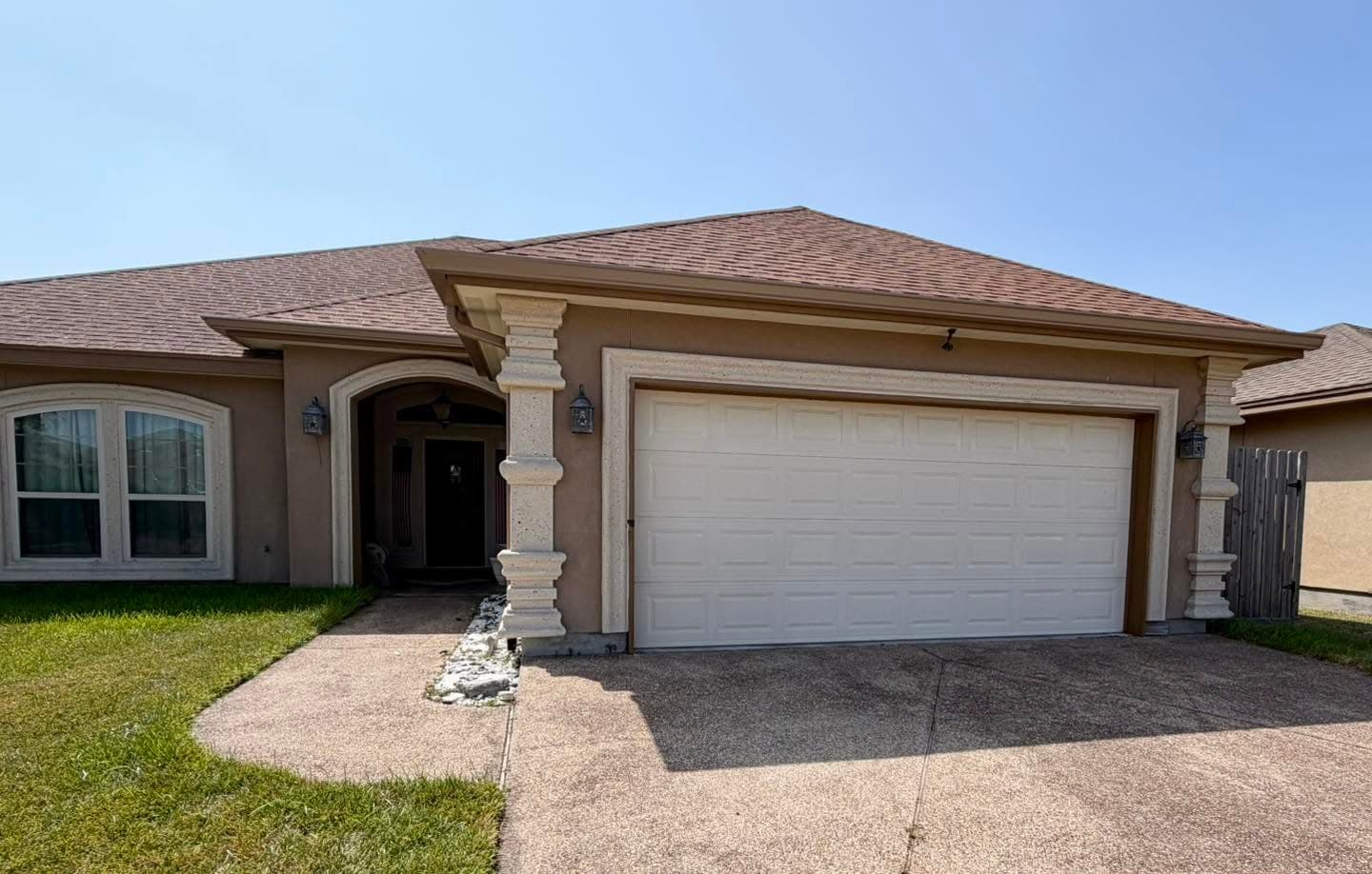 Seamless gutter run installed along the eave of a stucco home