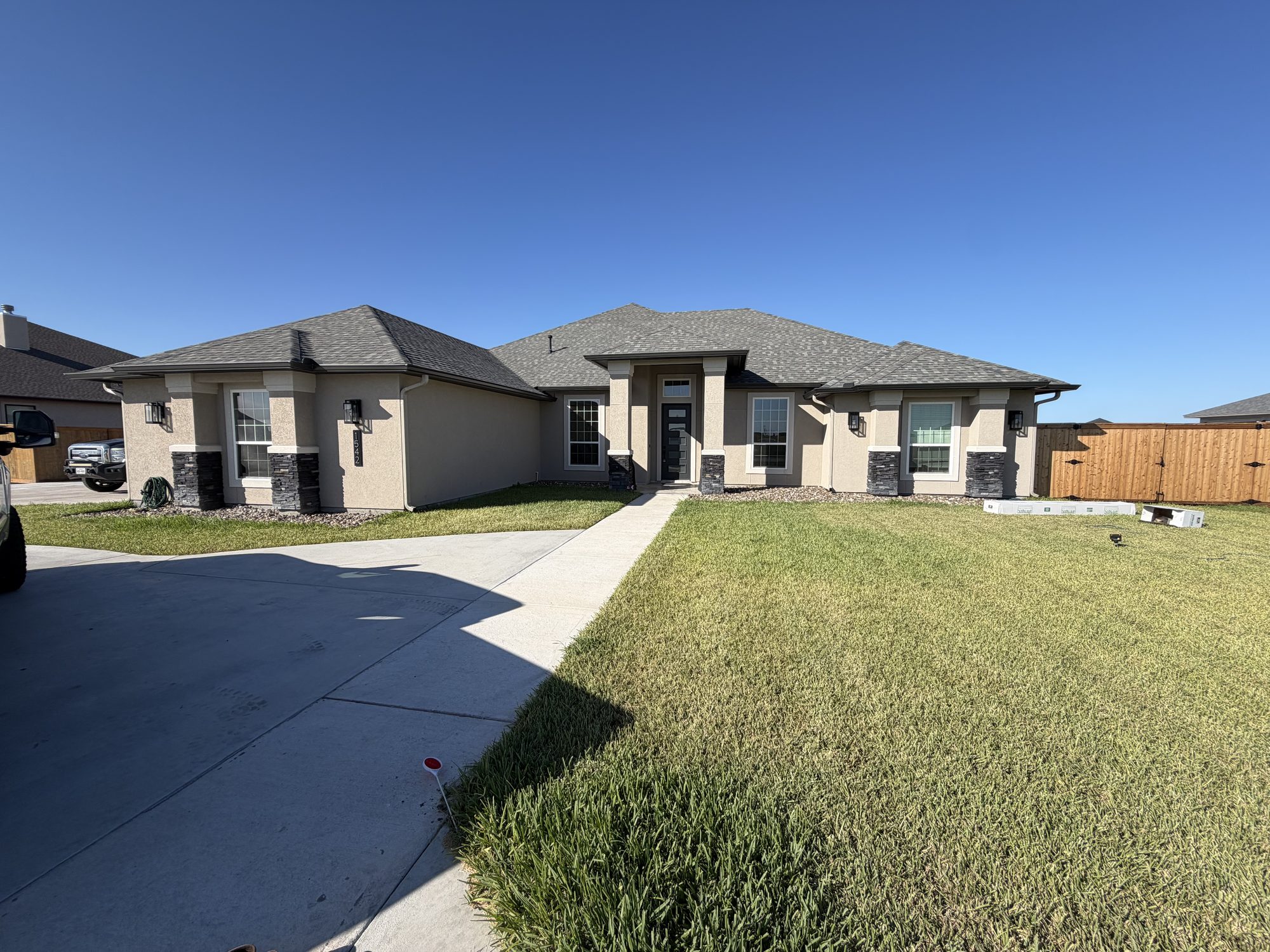 New beige stucco ranch with seamless gutters in the Corpus Christi area